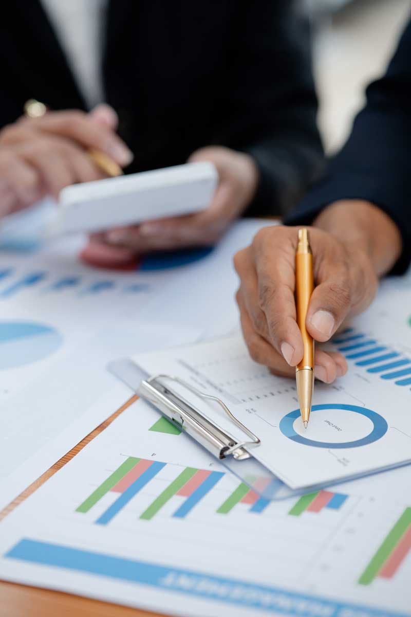 closeup of paperwork with financial graphs